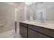 Modern bathroom featuring double sinks, sleek dark cabinetry, and a tiled shower with a glass door at 213 Clearpath Dr, Summerville, SC 29486
