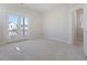 Bright, carpeted bedroom with double doors leading to a balcony and a separate doorway into another room at 213 Clearpath Dr, Summerville, SC 29486