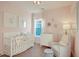 Cozy Bedroom with a white crib, changing table, and comfortable armchair, adorned with sweet animal-themed artwork at 213 Clearpath Dr, Summerville, SC 29486