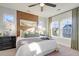 Relaxing main bedroom featuring a wood accent wall, stylish decor, and windows with a bright view at 213 Clearpath Dr, Summerville, SC 29486