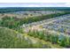 An aerial view showcases a community of modern homes with well-kept yards surrounded by green forests at 219 Whirlaway Dr, Moncks Corner, SC 29461