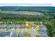 Desirable neighborhood aerial view showcasing a community surrounded by lush trees and a serene lake at 219 Whirlaway Dr, Moncks Corner, SC 29461