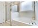 Bright bathroom with a soaking tub, separate glass-enclosed shower, and large window at 219 Whirlaway Dr, Moncks Corner, SC 29461