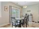 Charming dining area with wood floors, backyard views, modern lighting, and a coffee bar at 219 Whirlaway Dr, Moncks Corner, SC 29461