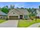 Charming single-story home with a well-manicured lawn and a two-car garage at 219 Whirlaway Dr, Moncks Corner, SC 29461
