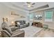 Cozy living room with a ceiling fan, large windows, and comfortable leather seating at 219 Whirlaway Dr, Moncks Corner, SC 29461