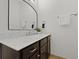 Modern bathroom boasts sleek, dark cabinets and a white marble countertop with contemporary fixtures at 221 Ashley Ave # Abc, Charleston, SC 29403