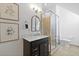 Well-lit bathroom featuring a glass shower, framed art, and a black vanity with stone countertop at 221 Ashley Ave # Abc, Charleston, SC 29403