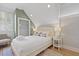 Bright and modern bedroom featuring sloped ceilings, a bed, and a spacious closet with ample storage at 221 Ashley Ave # Abc, Charleston, SC 29403