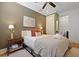 Cozy bedroom with a ceiling fan, soft bedding, and wooden nightstand at 221 Ashley Ave # Abc, Charleston, SC 29403