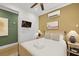 Cozy bedroom featuring a rattan bed frame, bedside tables with lamps, and a wall-mounted television at 221 Ashley Ave # Abc, Charleston, SC 29403