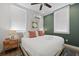 Bright bedroom features a king bed, modern art, and dual windows at 221 Ashley Ave # Abc, Charleston, SC 29403