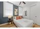 Comfortable bedroom with natural light and a decorative mirror at 221 Ashley Ave # Abc, Charleston, SC 29403