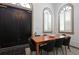 Dining area featuring a large wooden table and arched windows at 221 Ashley Ave # Abc, Charleston, SC 29403