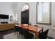 Dining area with a wooden table adjacent to a living room with fireplace and wet bar at 221 Ashley Ave # Abc, Charleston, SC 29403
