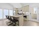 A modern kitchen with stainless steel appliances, granite counters, and a breakfast bar with seating at 221 Ashley Ave # Abc, Charleston, SC 29403