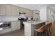 Modern kitchen with granite countertops, stainless steel appliances, and seating at the island at 221 Ashley Ave # Abc, Charleston, SC 29403