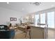 Bright living area with neutral decor, a modern kitchen, and plenty of natural light from the glass doors at 221 Ashley Ave # Abc, Charleston, SC 29403