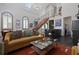 Stylish living room with high ceilings, staircase, modern decor, and natural light at 221 Ashley Ave # Abc, Charleston, SC 29403