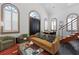 Bright living area with high ceilings, arched windows, a plush sofa, and a glass coffee table at 221 Ashley Ave # Abc, Charleston, SC 29403