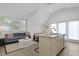 Bright living room with comfortable seating, a decorative mirror, and an open layout with kitchen view at 221 Ashley Ave # Abc, Charleston, SC 29403