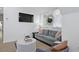 Comfortable living area with a stylish gray sofa, round lattice coffee table, and large flat-screen television at 221 Ashley Ave # Abc, Charleston, SC 29403