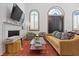 Cozy living room featuring a fireplace, comfortable seating, and plenty of natural light at 221 Ashley Ave # Abc, Charleston, SC 29403