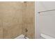 Tiled shower with bronze fixtures and a white tub provides a clean and modern bathing space at 221 Ashley Ave # Abc, Charleston, SC 29403