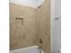 Shower and tub with bronze fixtures and neutral tile at 221 Ashley Ave # Abc, Charleston, SC 29403