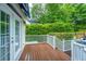 Inviting back deck with white railings and lush greenery provides a peaceful outdoor setting at 23 Forde Row, Charleston, SC 29412