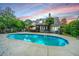 Inviting backyard oasis featuring a sparkling pool, a covered patio, and lush greenery for outdoor relaxation at 23 Forde Row, Charleston, SC 29412