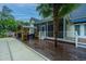 Backyard boasts a screened porch, outdoor seating, and a backdrop of lush greenery and a sparkling pool at 23 Forde Row, Charleston, SC 29412
