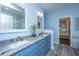 Stylish bathroom with a double sink vanity, granite countertops, and wood look floors at 23 Forde Row, Charleston, SC 29412