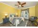 Bright bedroom featuring french doors to the backyard, yellow walls, and a ceiling fan at 23 Forde Row, Charleston, SC 29412