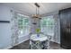 Breakfast nook featuring a decorative chandelier, matching window treatments, and an adjacent kitchen at 23 Forde Row, Charleston, SC 29412
