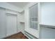 Spacious walk-in closet with custom shelving, wood floors, and a window seat at 23 Forde Row, Charleston, SC 29412