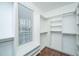 Large walk-in closet with custom shelving and ample storage space with a window at 23 Forde Row, Charleston, SC 29412