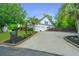 Wide driveway leading to a well-maintained home with lush landscaping, a mailbox, and an attached two-car garage at 23 Forde Row, Charleston, SC 29412