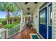Inviting front porch with rocking chairs, a stylish door, and a charming entryway, perfect for relaxing outdoors at 23 Forde Row, Charleston, SC 29412