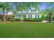 Charming two-story home featuring a well-manicured lawn and blue shutters, creating a welcoming curb appeal at 23 Forde Row, Charleston, SC 29412