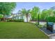 Beautiful home featuring a lush green lawn, complemented by mature trees and meticulously maintained landscaping at 23 Forde Row, Charleston, SC 29412