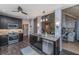 Kitchen with granite counters and stainless appliances, flowing into the dining and living areas with fireplace at 23 Forde Row, Charleston, SC 29412