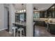 Open kitchen featuring granite counters, dark cabinets, stainless appliances, and a breakfast bar with seating at 23 Forde Row, Charleston, SC 29412