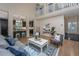 Open-concept living room featuring a cozy seating area, hardwood floors, and a view of the modern kitchen at 23 Forde Row, Charleston, SC 29412