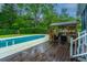 Inviting backyard pool featuring a covered lounge area and spacious deck, perfect for outdoor relaxation and entertaining at 23 Forde Row, Charleston, SC 29412