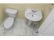 Compact bathroom featuring tile floors, a toilet, and a pedestal sink with a classic design at 250 Grand Oaks Dr, Ladson, SC 29456