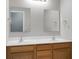 Bathroom featuring double sink vanity with wood cabinets, white countertop, and large mirrors at 250 Grand Oaks Dr, Ladson, SC 29456
