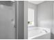 Bright bathroom featuring a window, tub, and shower at 250 Grand Oaks Dr, Ladson, SC 29456