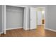 An empty bedroom features wood-look floors and a door leading into the en-suite bathroom at 250 Grand Oaks Dr, Ladson, SC 29456