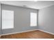 Bright bedroom with wood floors, neutral walls, and ample natural light from two windows at 250 Grand Oaks Dr, Ladson, SC 29456